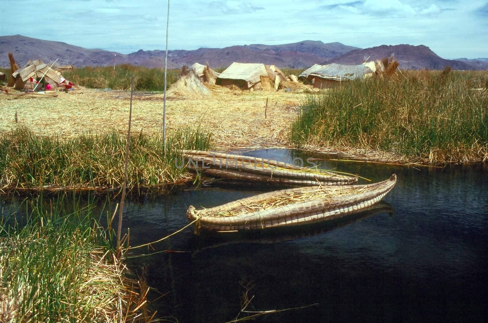 Lake Titicaca with island and boat made from totora