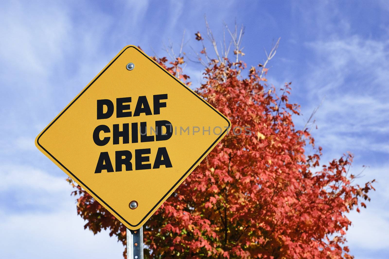Yellow street sign warning about deaf child
