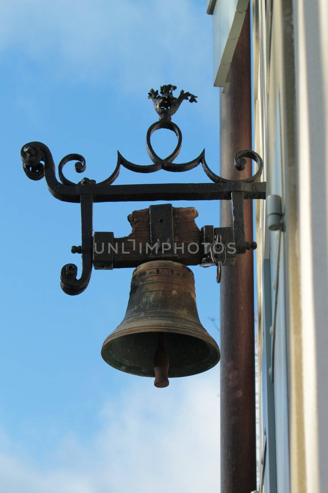 Old beautiful metallic bell on a wall