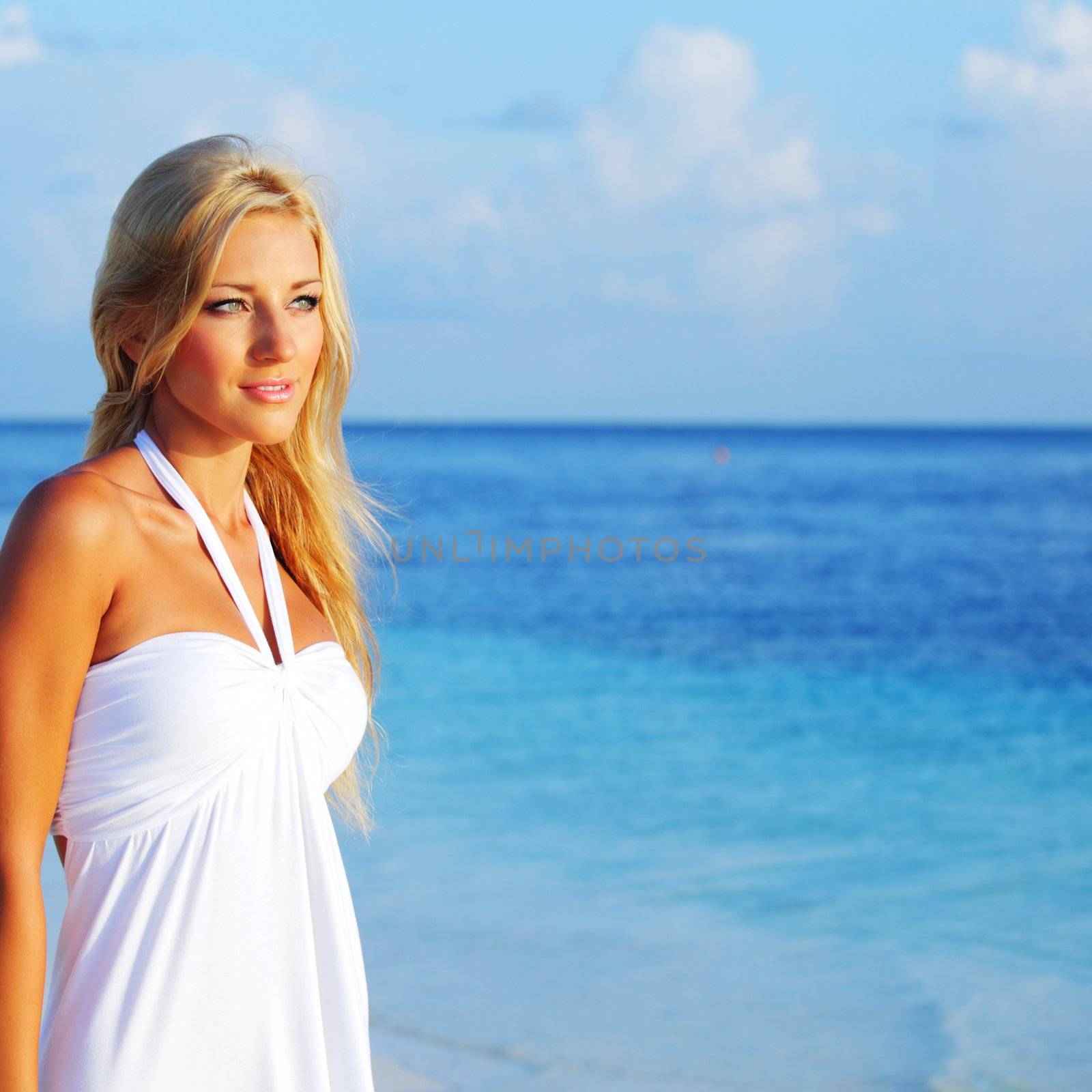 woman in a white dress on the ocean coast