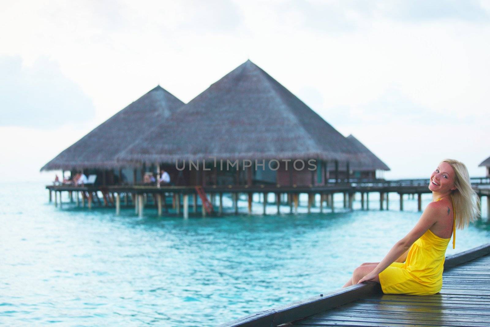 woman on tropical beach house back on the background