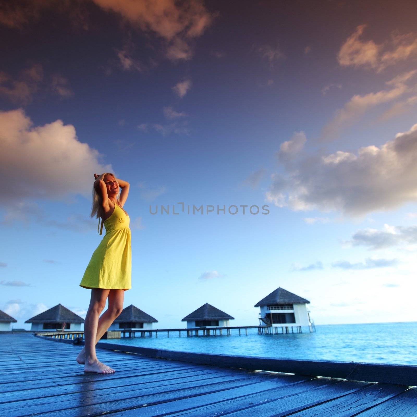 woman in a dress on maldivian sunset by Yellowj