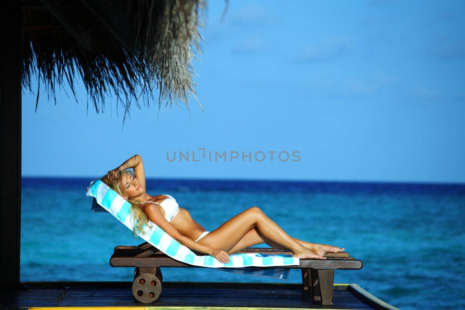 woman on lounge sea on background