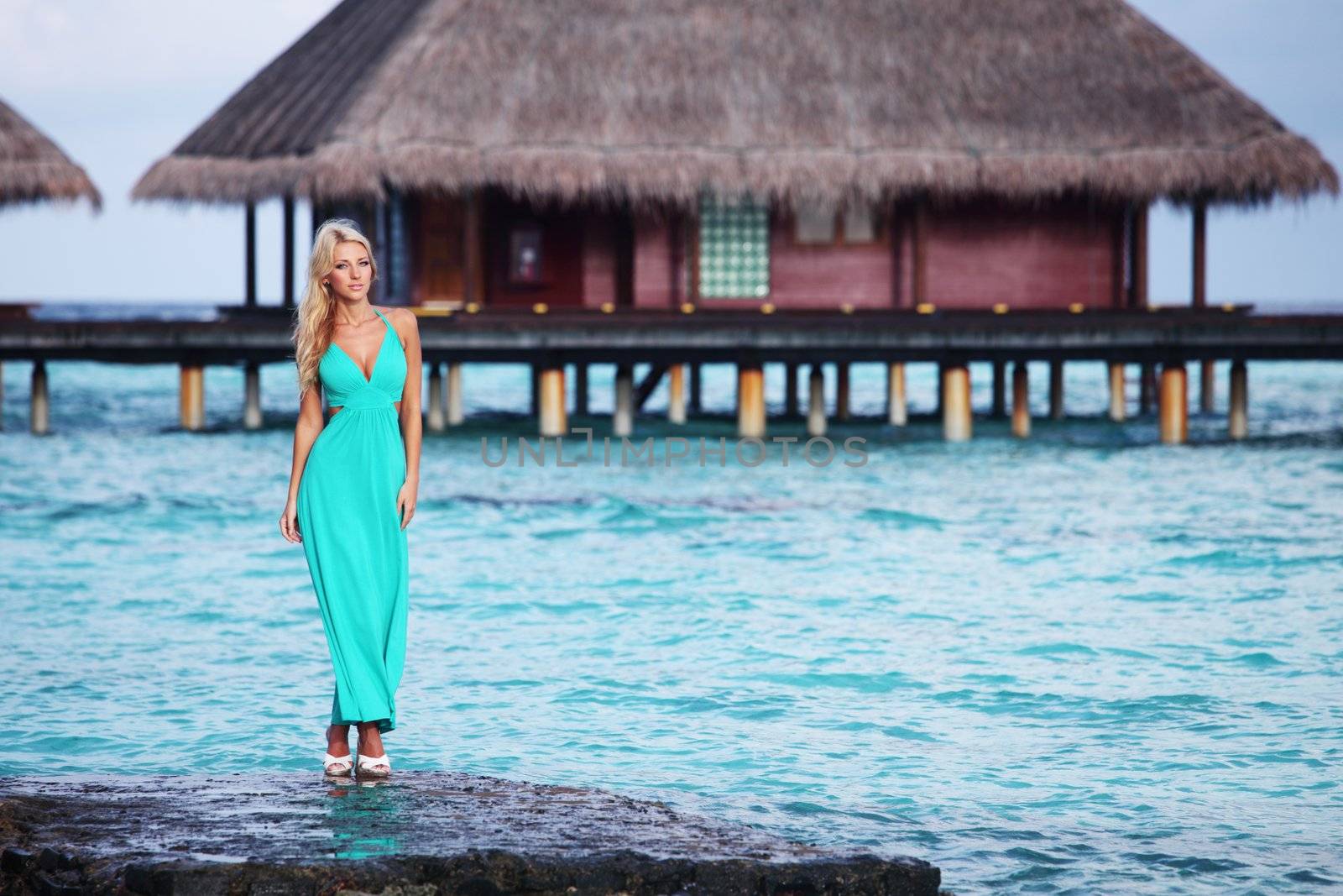 woman on tropical beach house back on the background