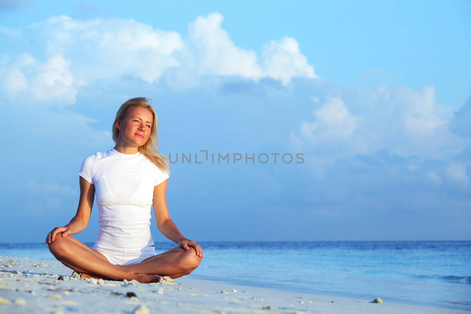 yoga woman on sea coast by Yellowj