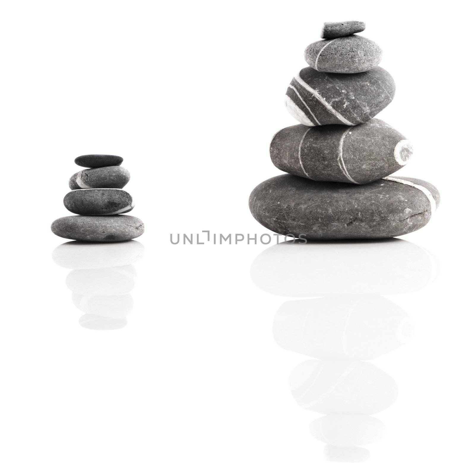 Stones pyramid isolated on white background with reflection