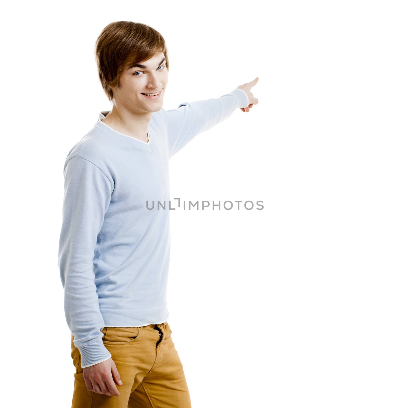 Young man showing something and pointing, isolated on white background