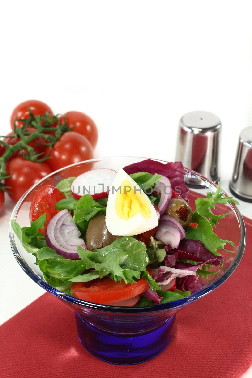 a blue bowl with mixed salad