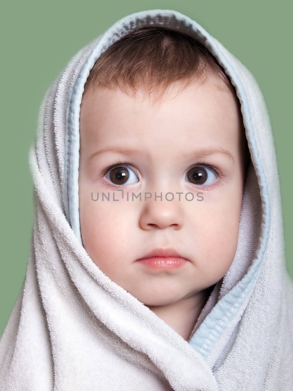 Cute little human baby child eyes on face in towel