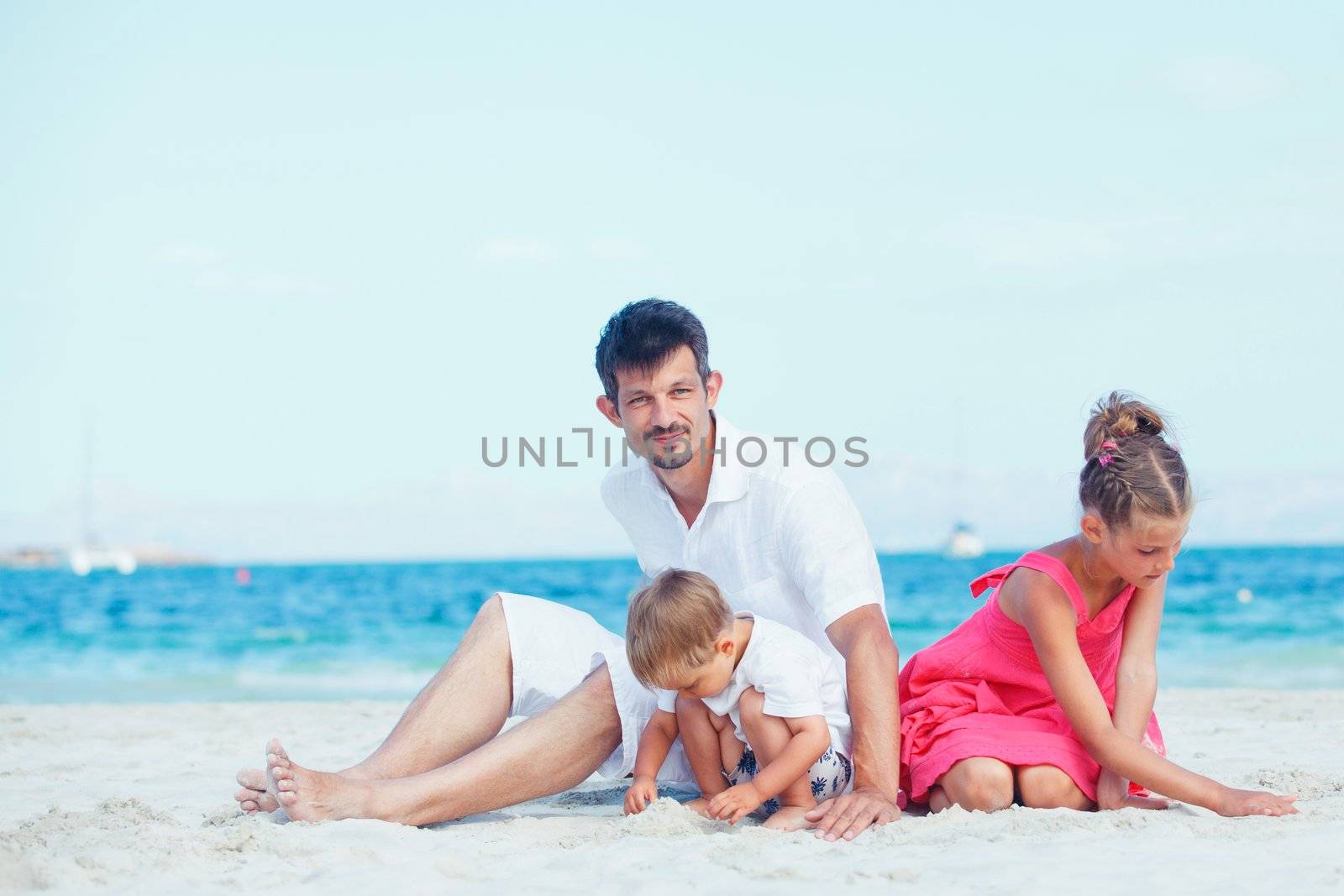 Cute father and her child playing happily at pretty beach