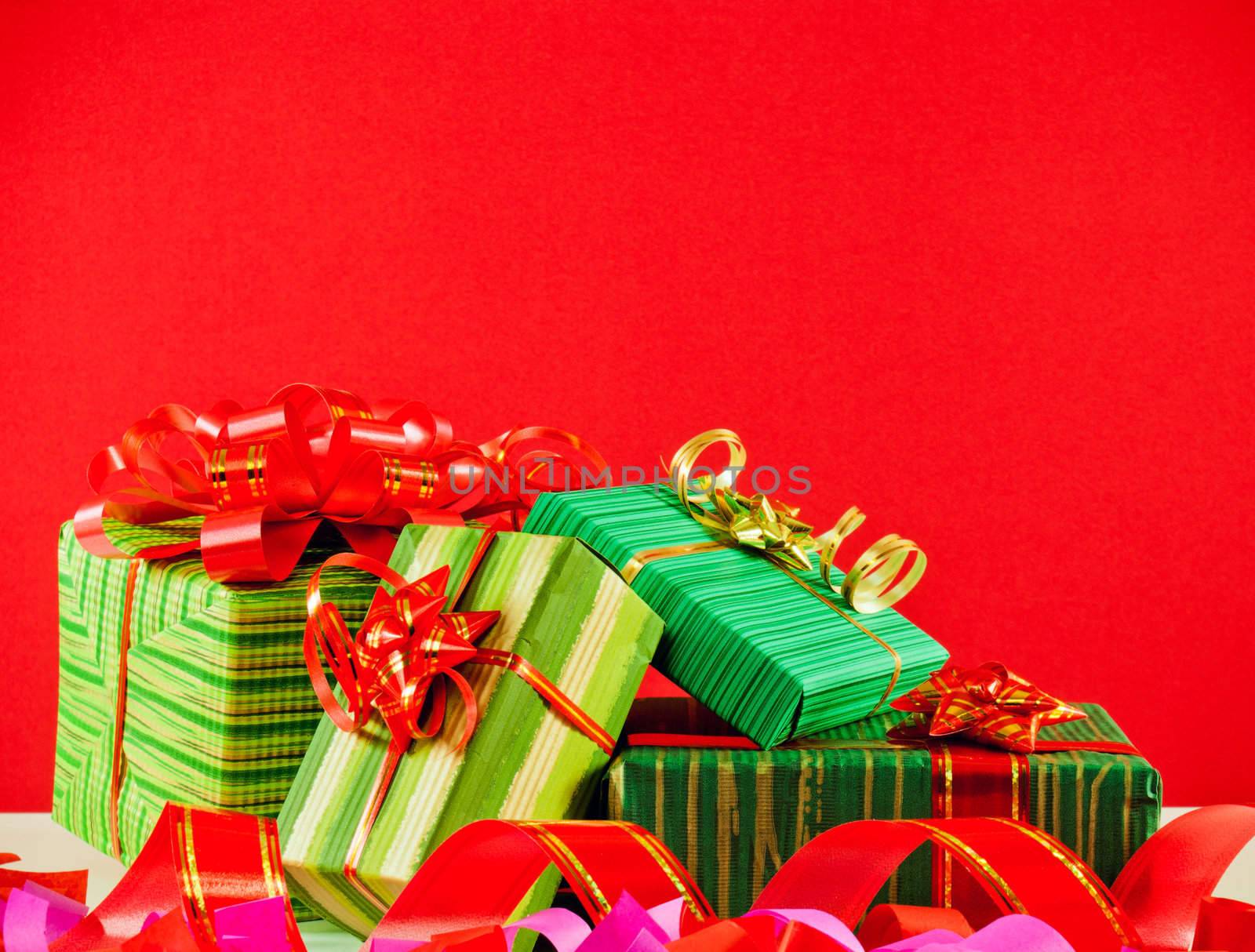 Wrapped boxes with presents against red background