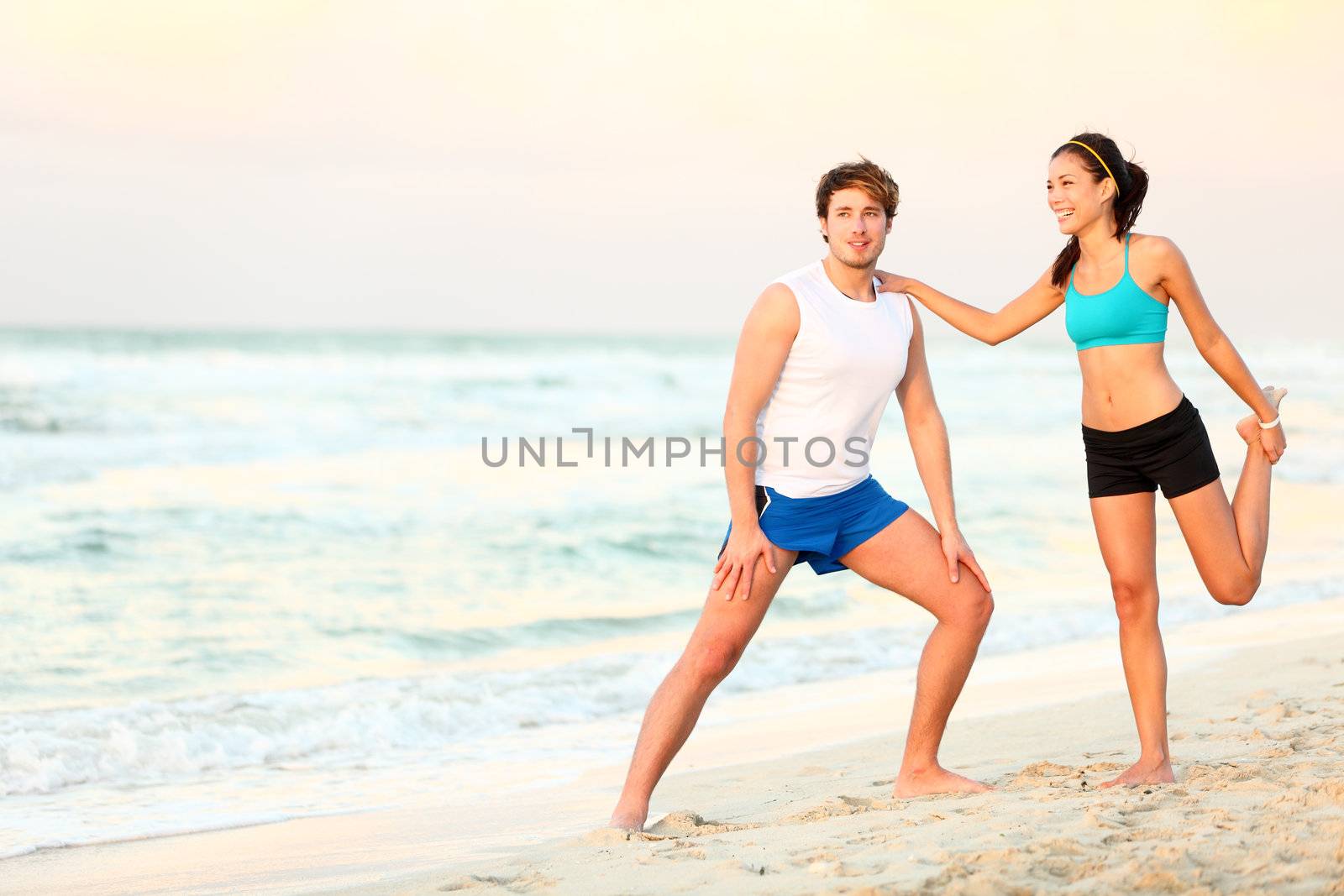 Couple workout training on beach by Maridav