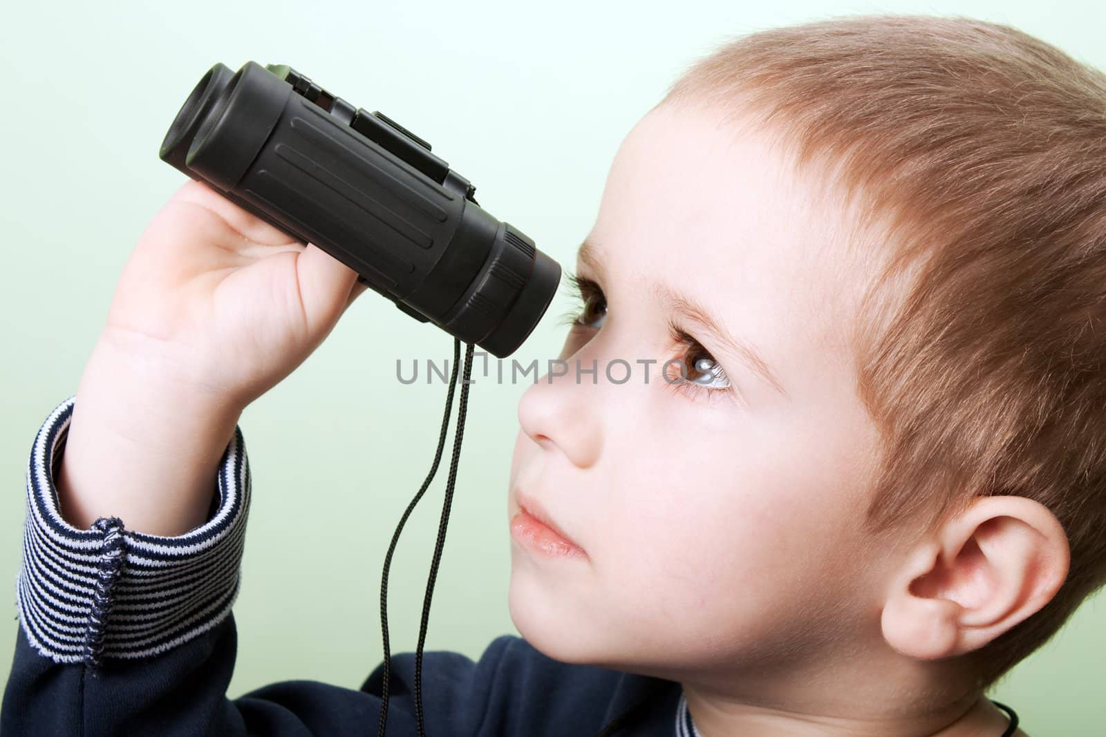 Little child boy looking binoculars lens isolated