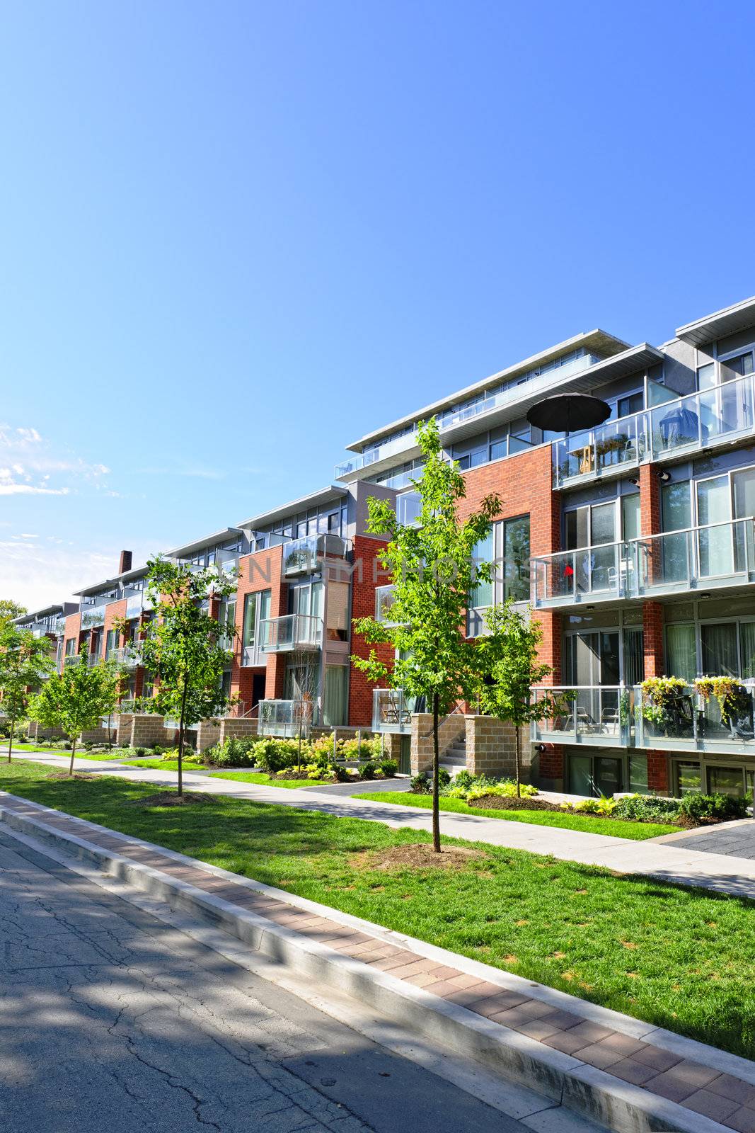 Modern town houses of brick and glass on urban street