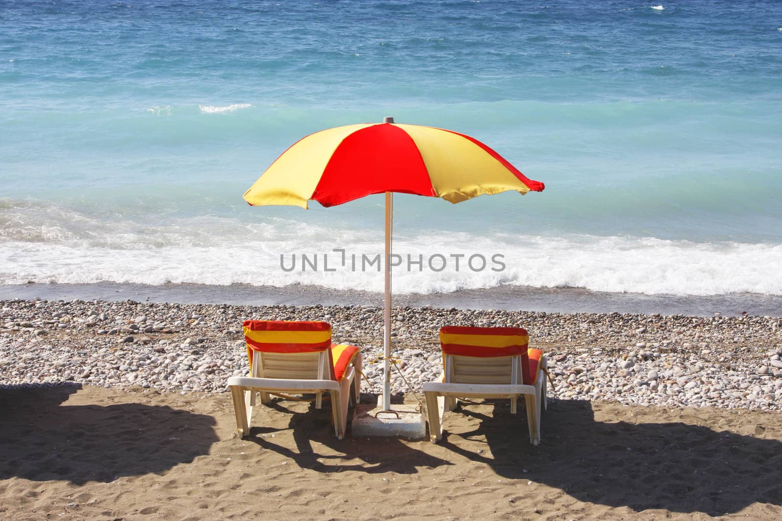 Beach chairs and umbrella on a beach