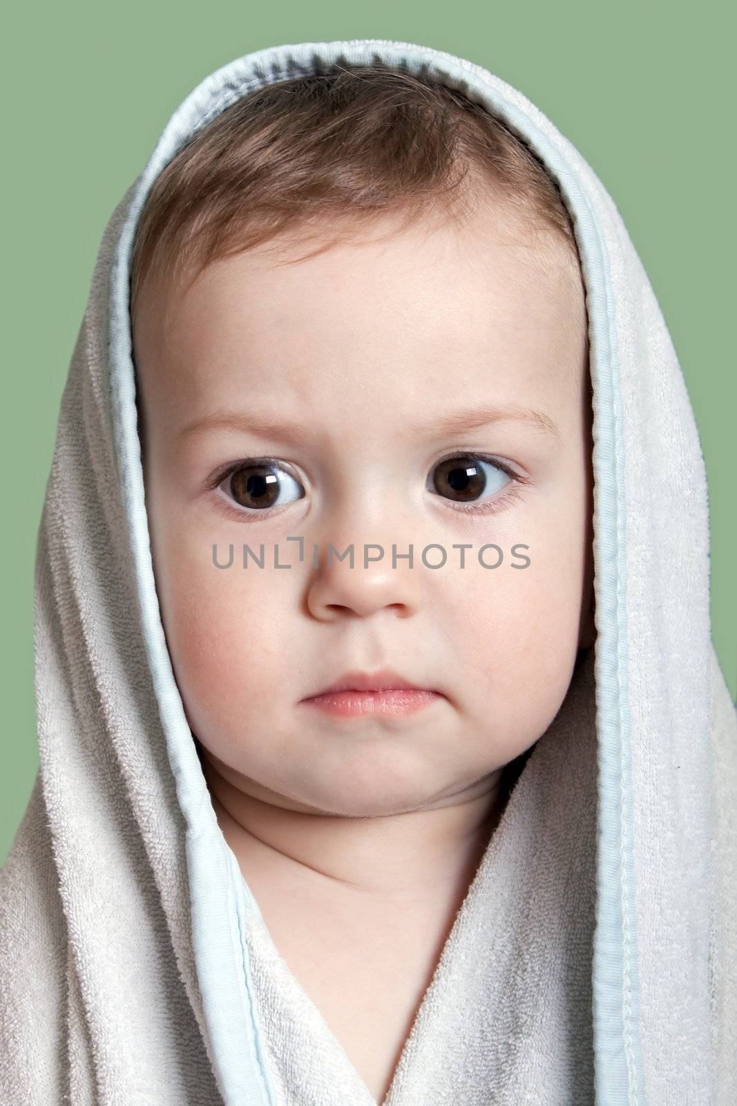 Cute little human baby child eyes on face in towel