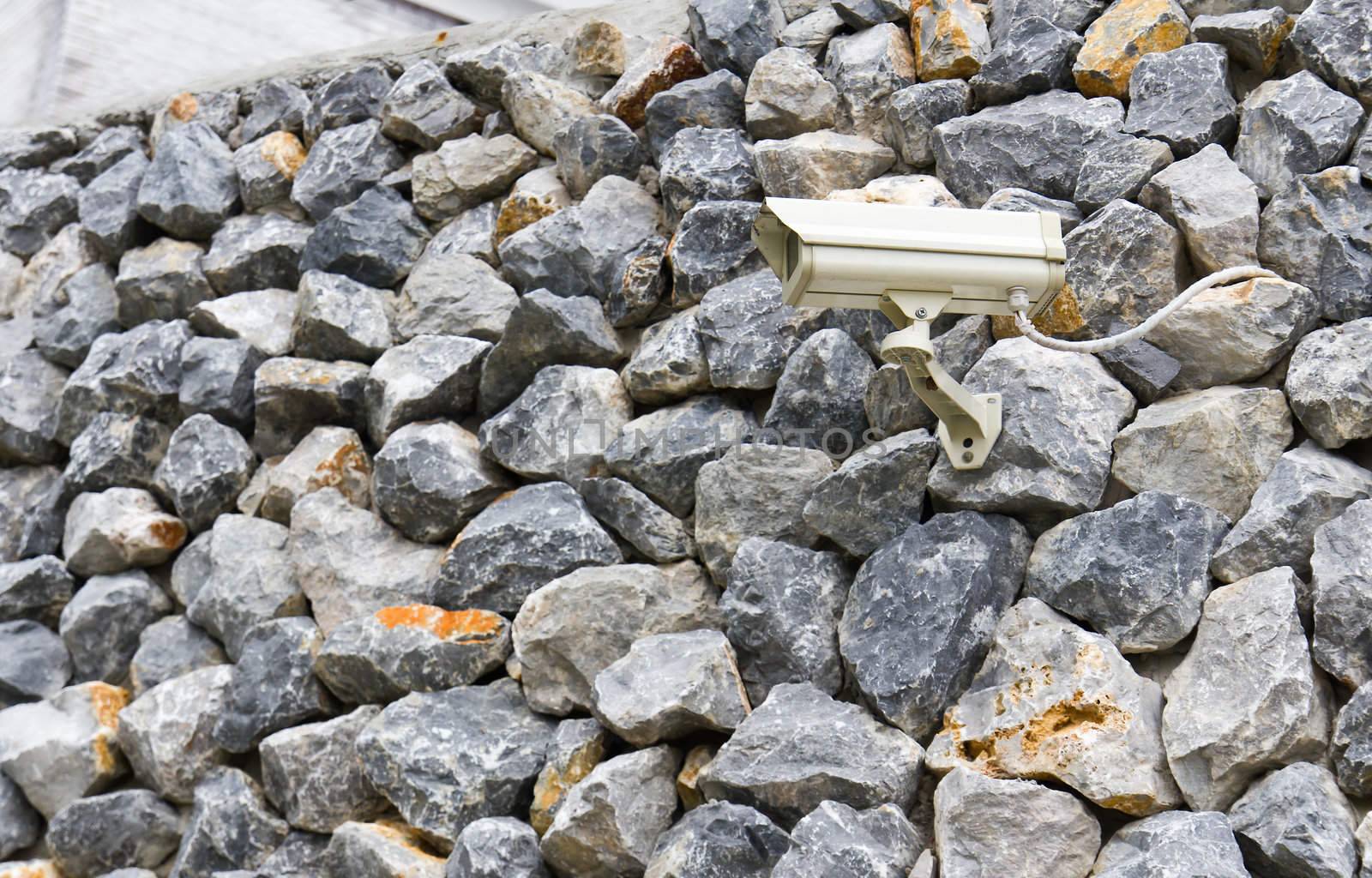 CCTV camera against on rock wall