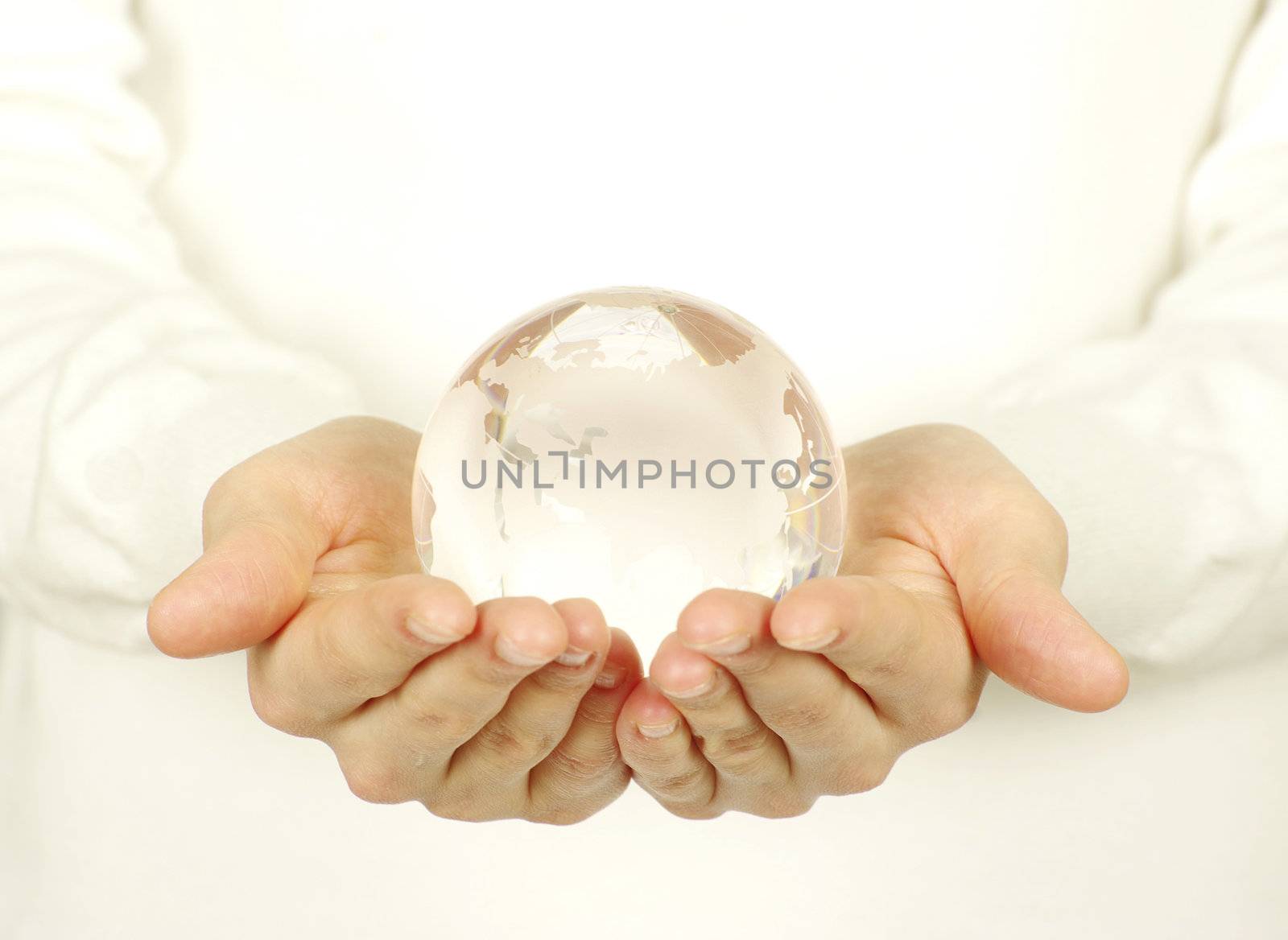 globe on the human hand on white