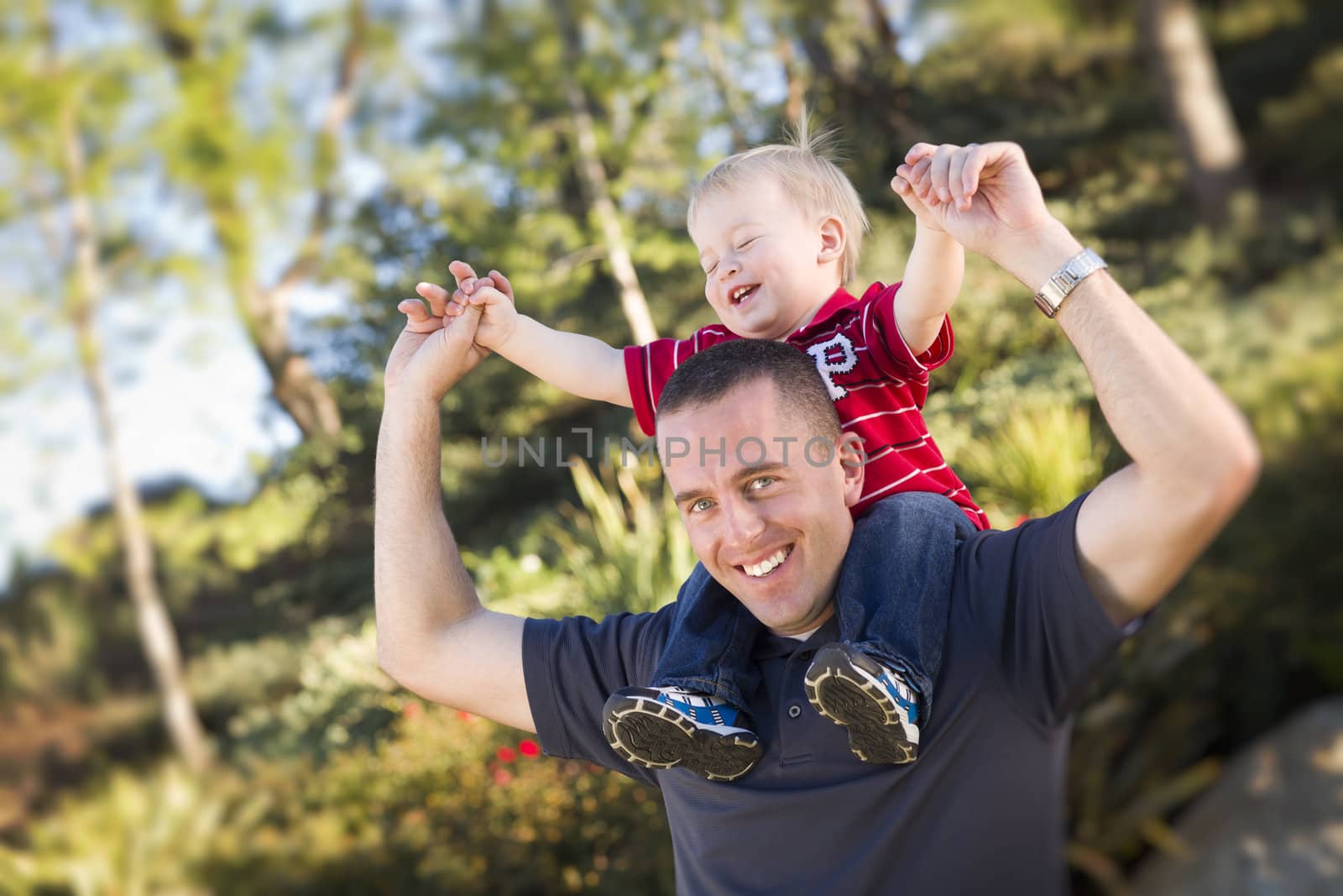 Young Laughing Father and Child  Having Piggy Back Fun.