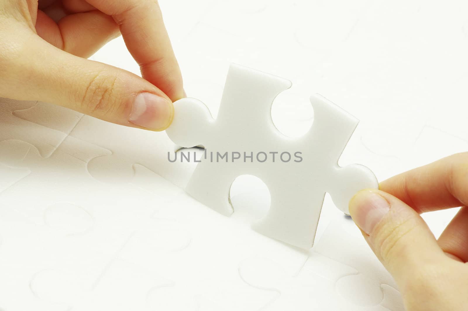 hands holding a puzzle piece . business concepts