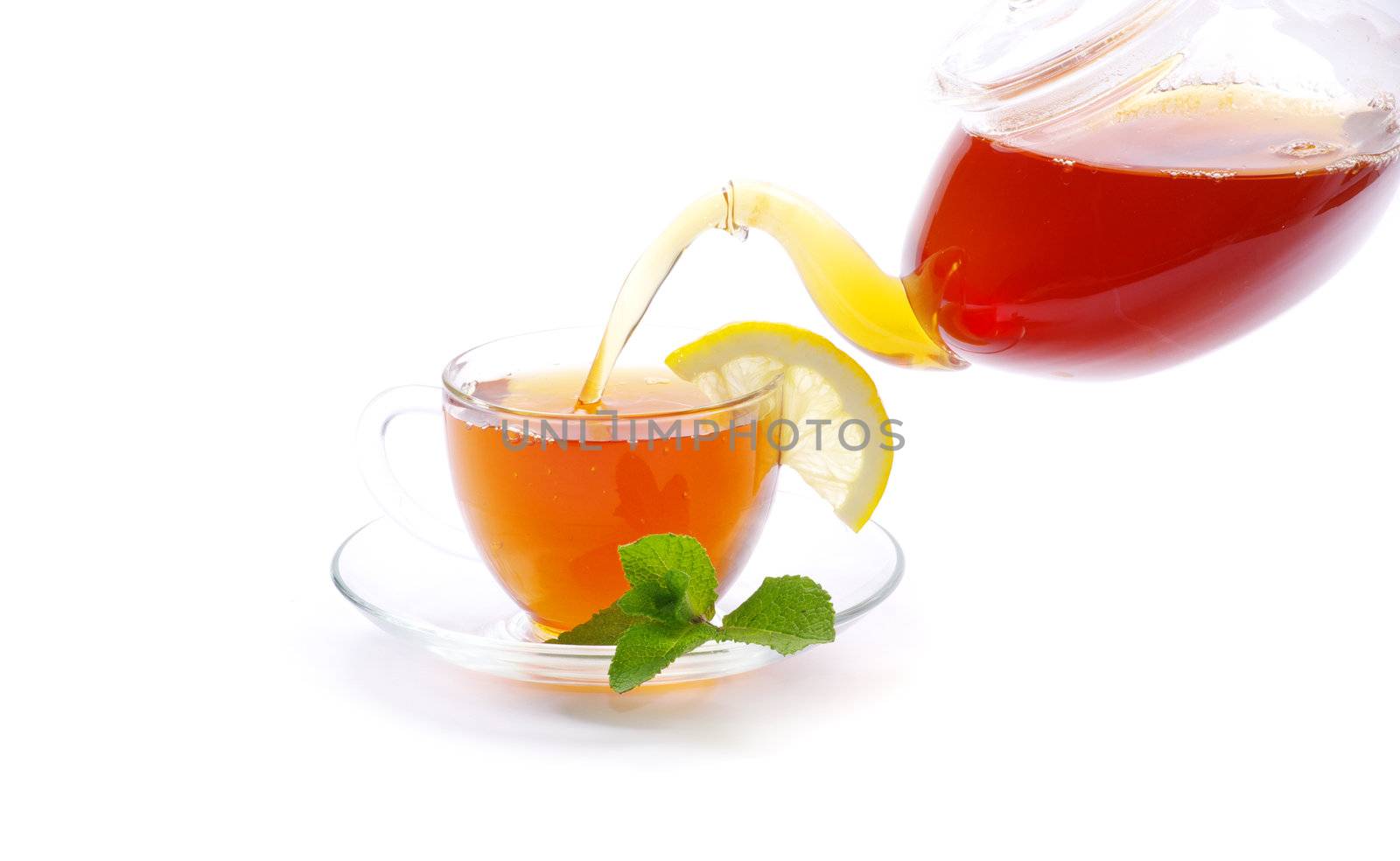 Tea being poured into glass tea cup
