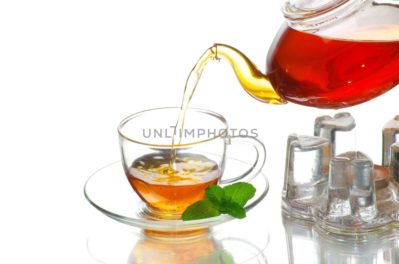 Tea being poured into glass tea cup