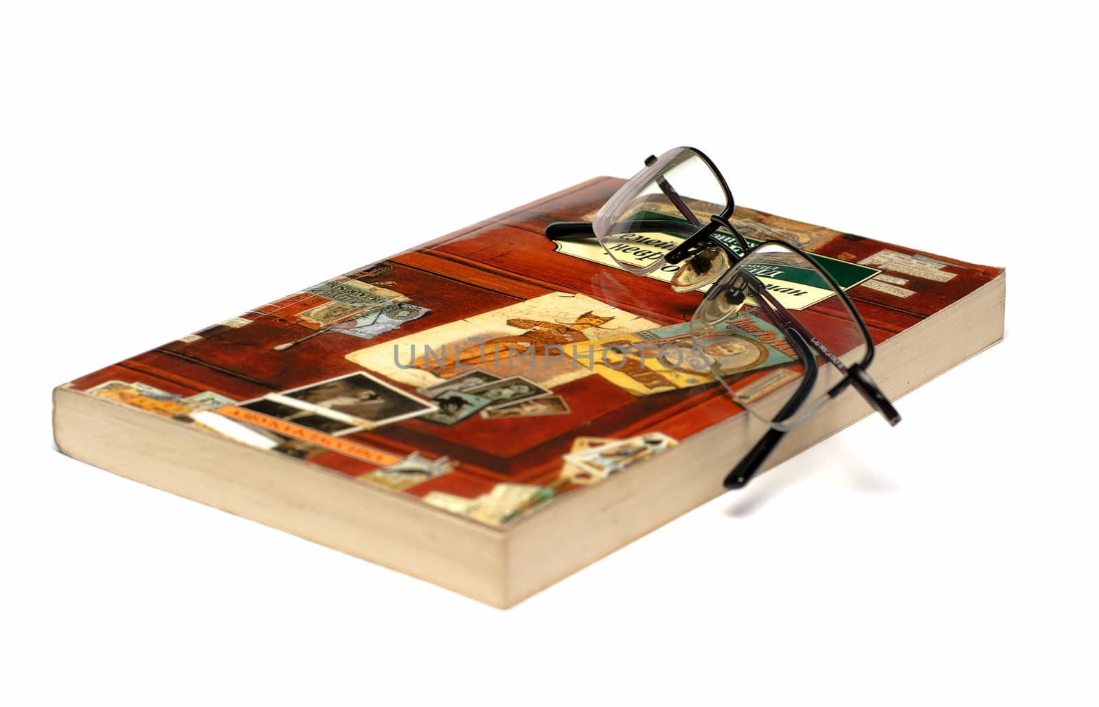 In black-rimmed glasses lie on a colorful book