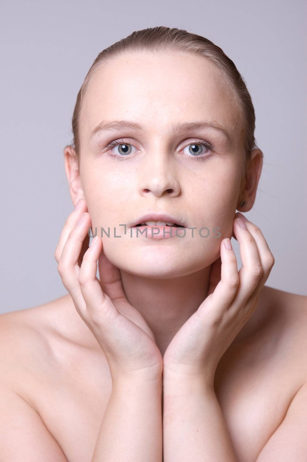 Young girl touching her face, like a tree.