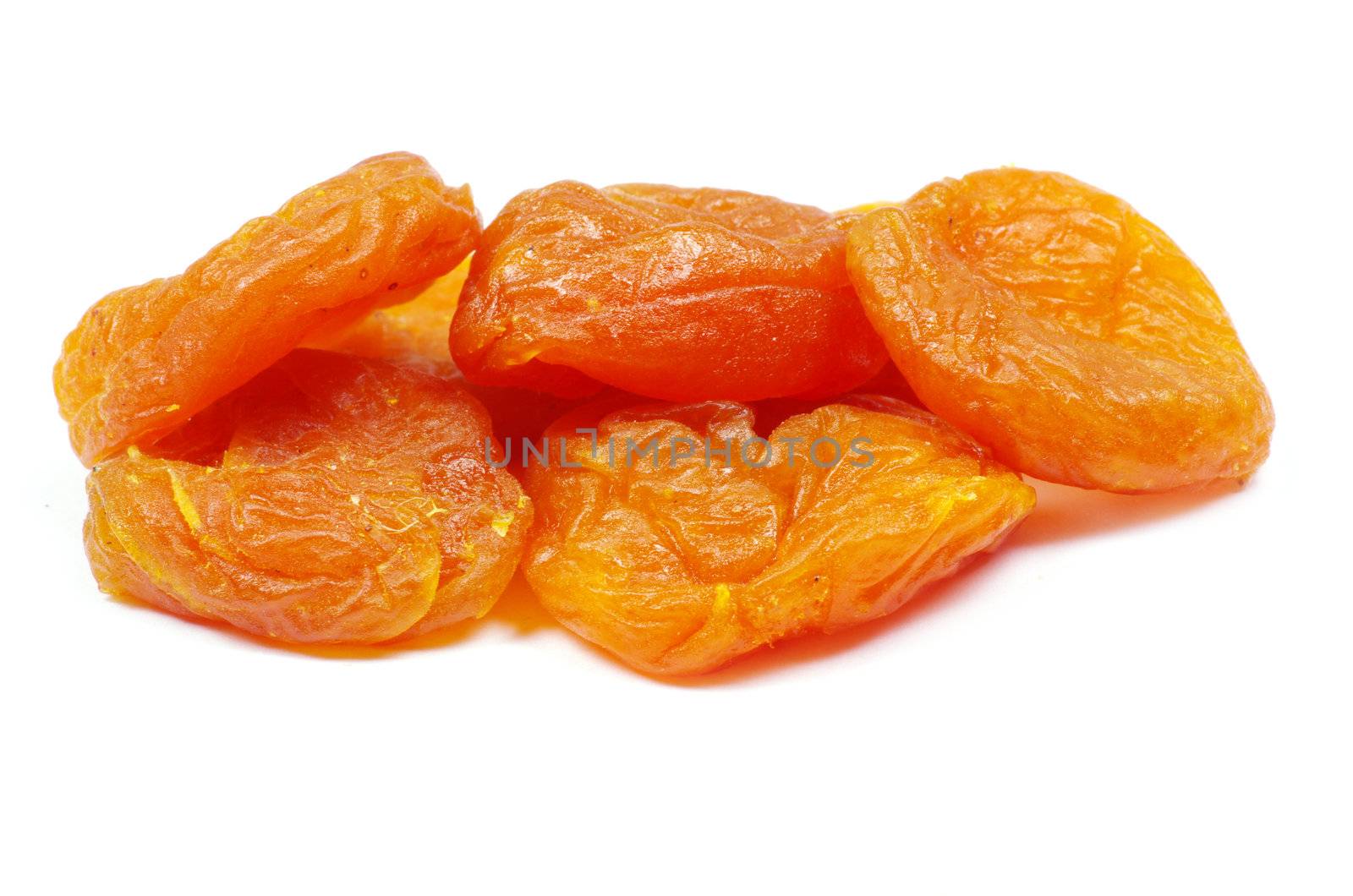 heap of dried apricots over white