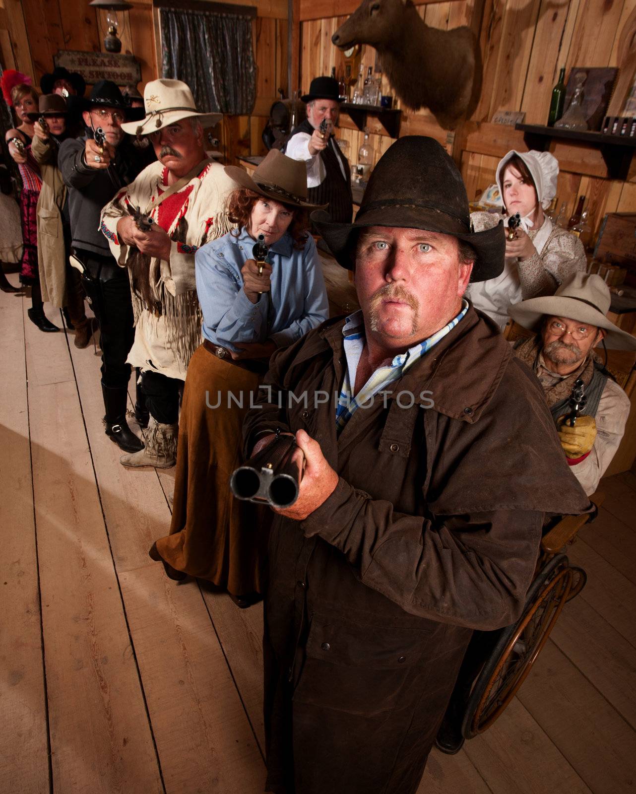 The entire saloon points their guns at an unseen danger.