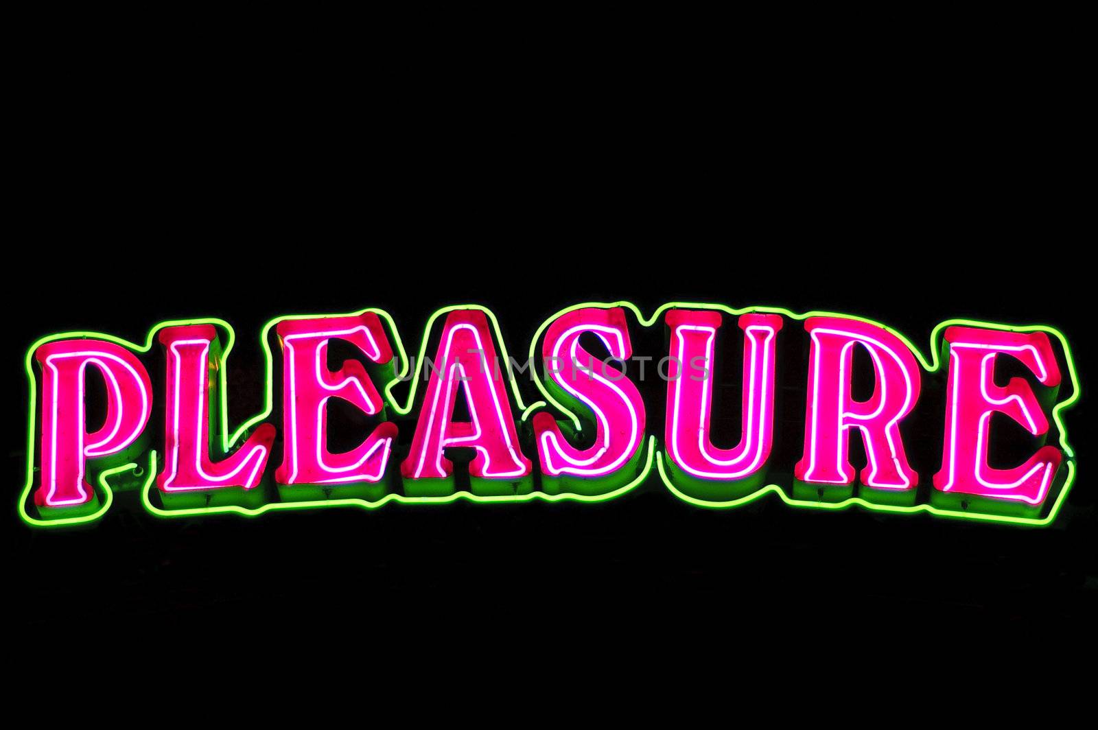Bright neon sign with the word pleasure in pink and green at night