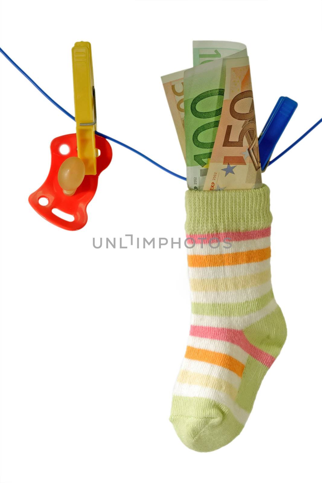 Baby socks with pacifier and euro banknotes on aclothline. Isolated on white background.