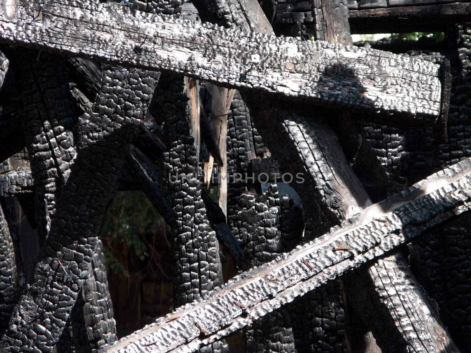 Ruined wood log house burnt by fire to black coal