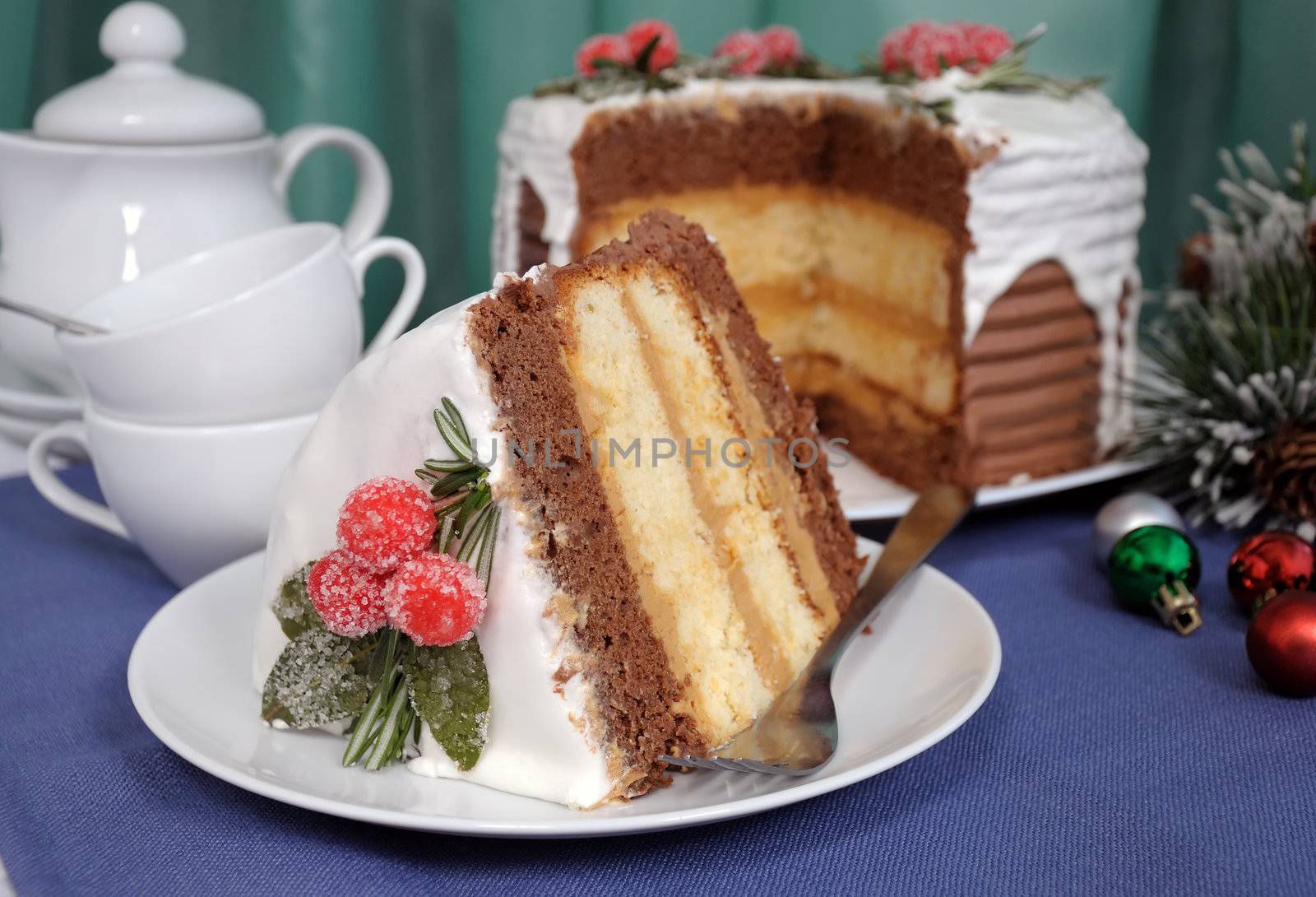A piece of sponge cake layered with cream under a white glaze