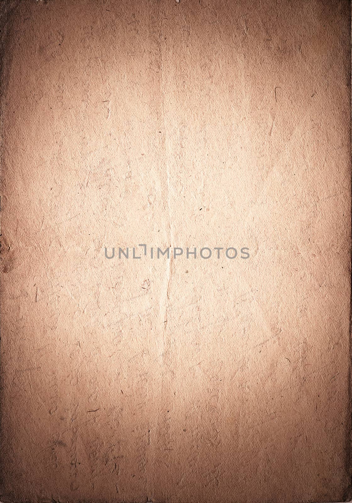 Vintage paper with vignette and light spot in the center. Brown color. Vertical orient.