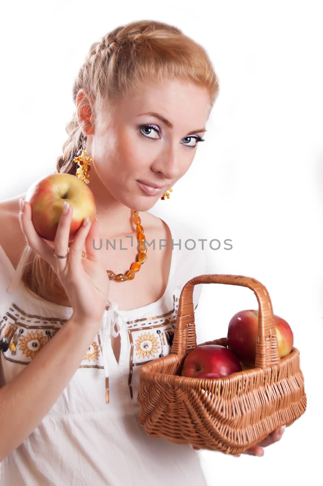 Redheaded woman with basket of apples over white