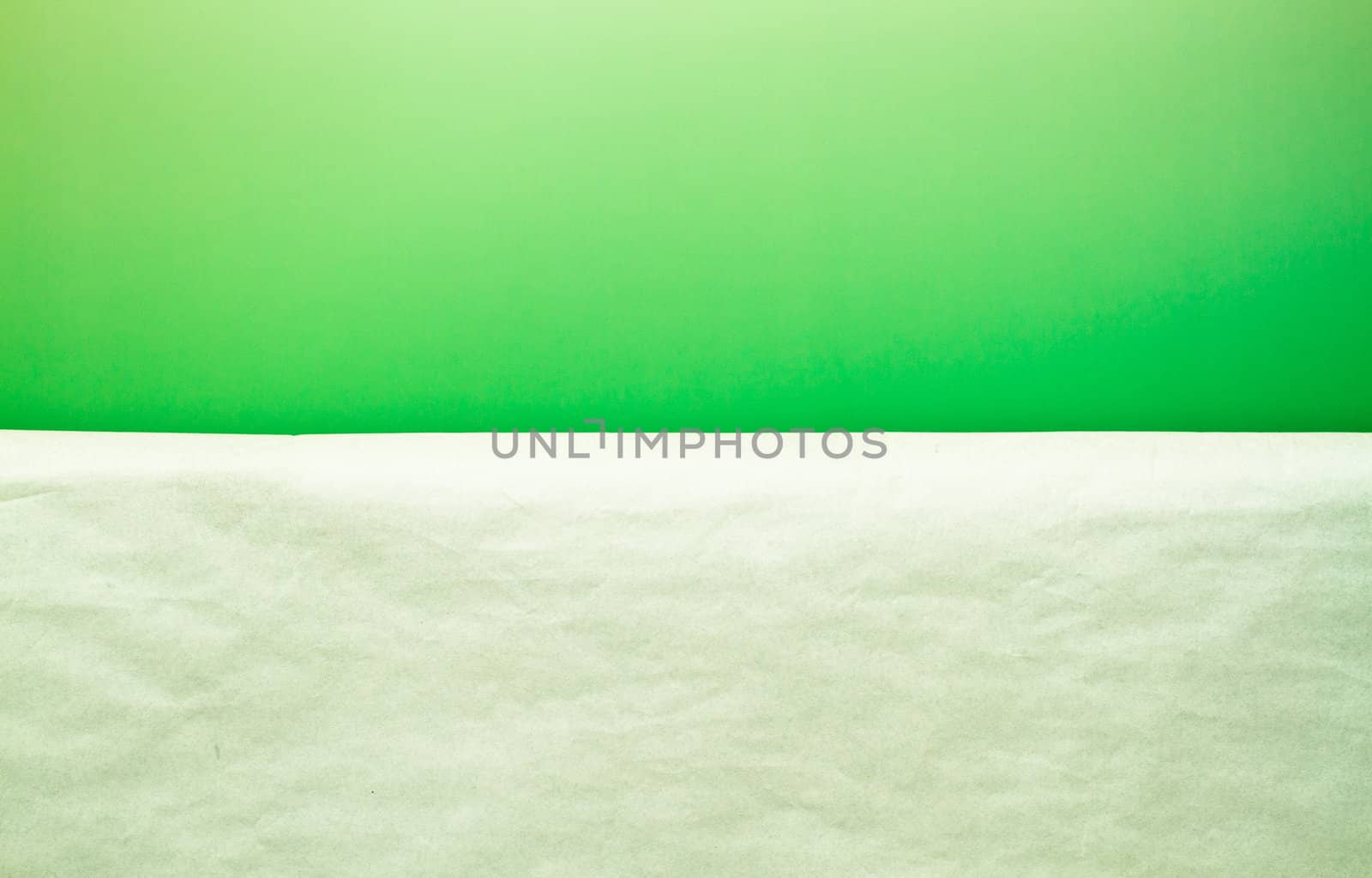 a white paper in front of green paper background serve as a simple background