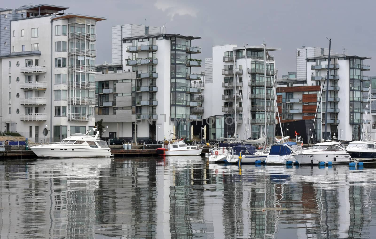 Modern apartments by the sea with modern boats and classy style.