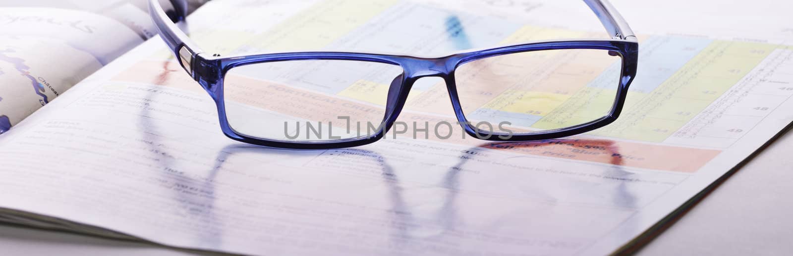 glasses lie on the magazine by Discovod