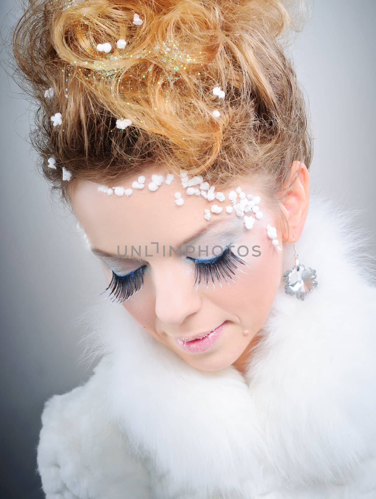 Closeup portrait of young beautiful girl with fantasy winter make-up