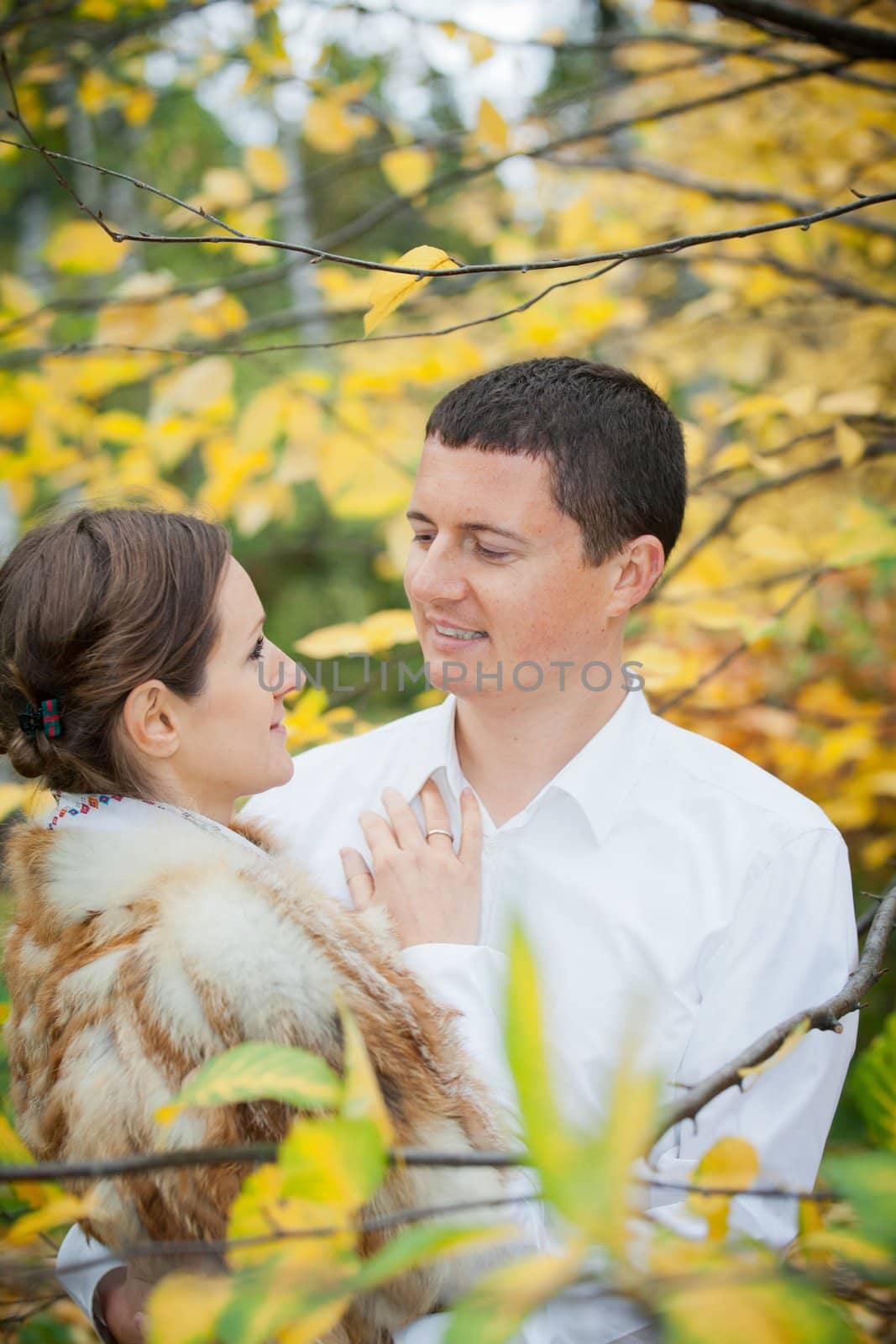 Portrait of romantic happy young beautiful couple on autumn walk. Vertical view