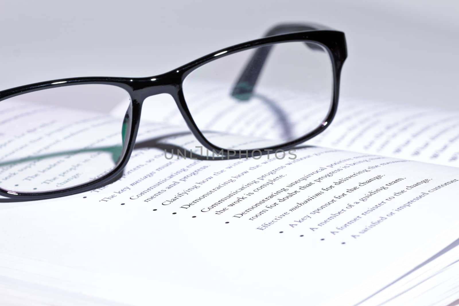 photo of eyeglasses lie on the book