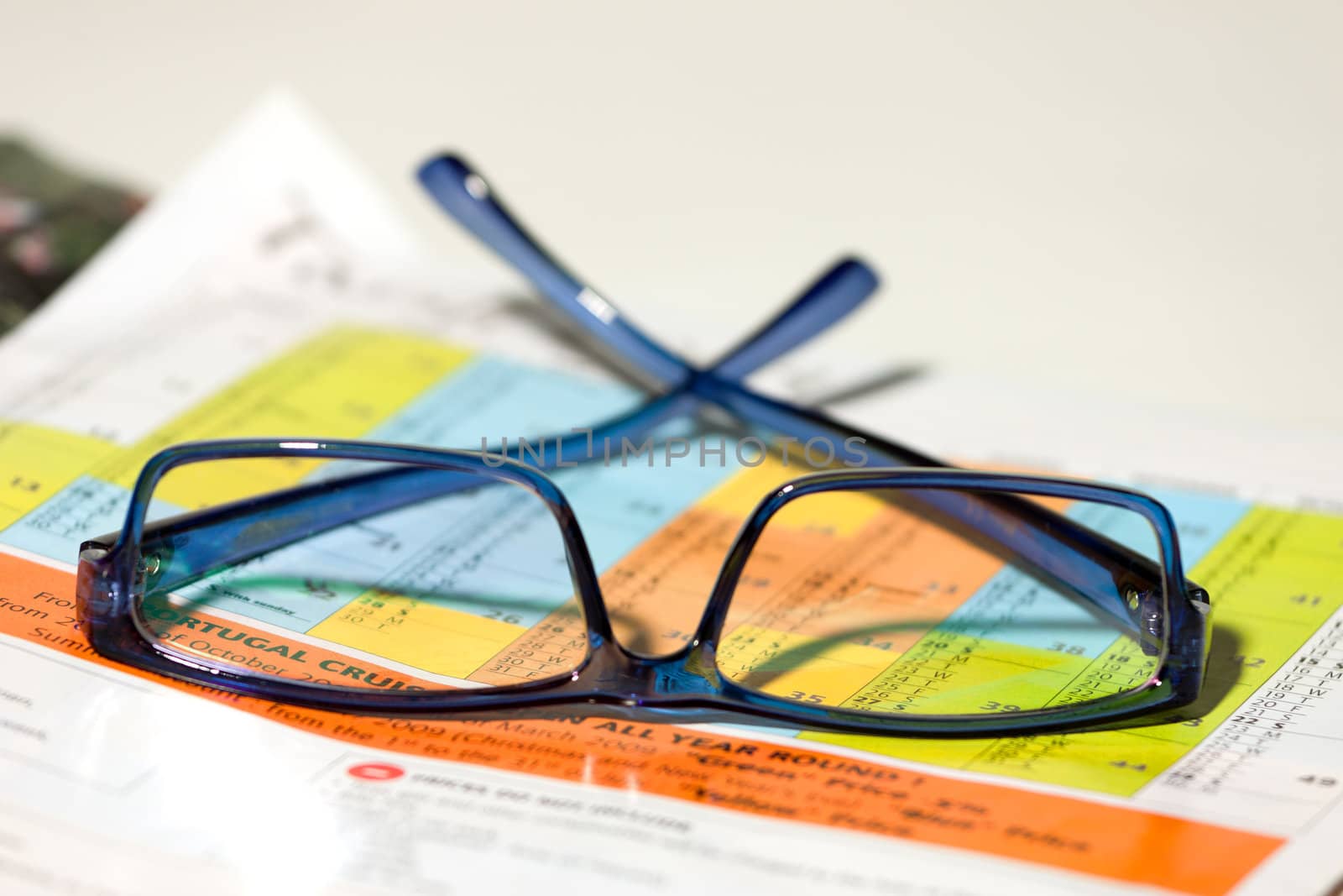 eyeglasses lie on the magazine by Discovod