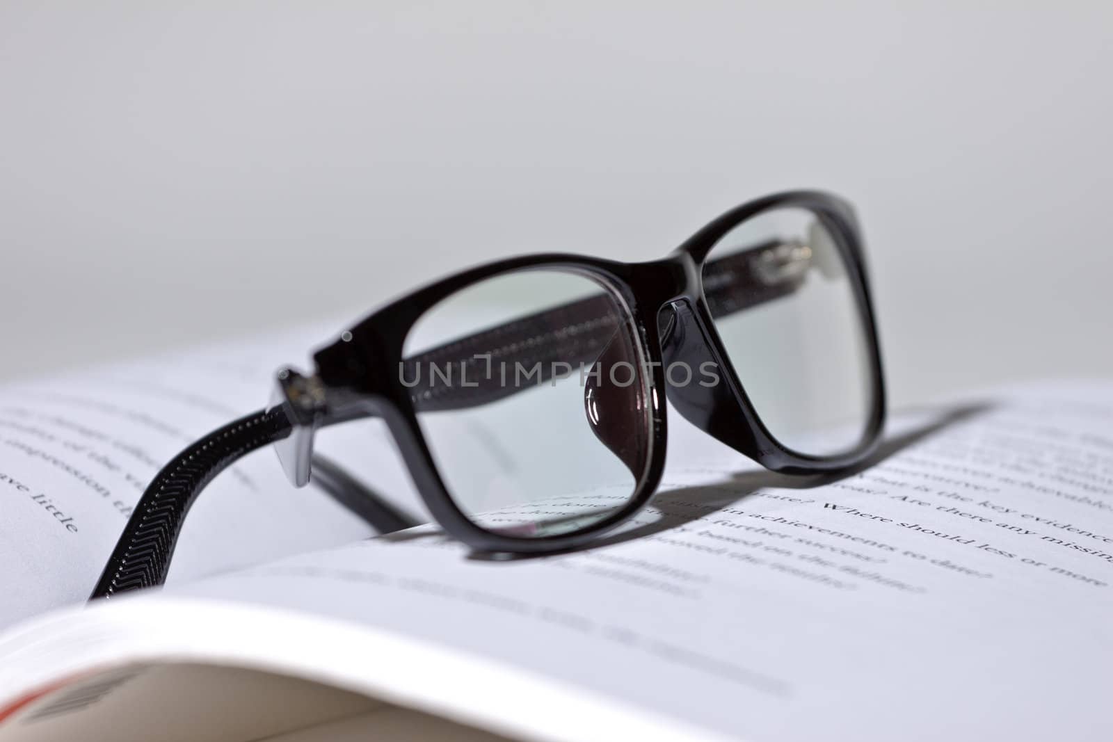eyeglasses lie on the book by Discovod
