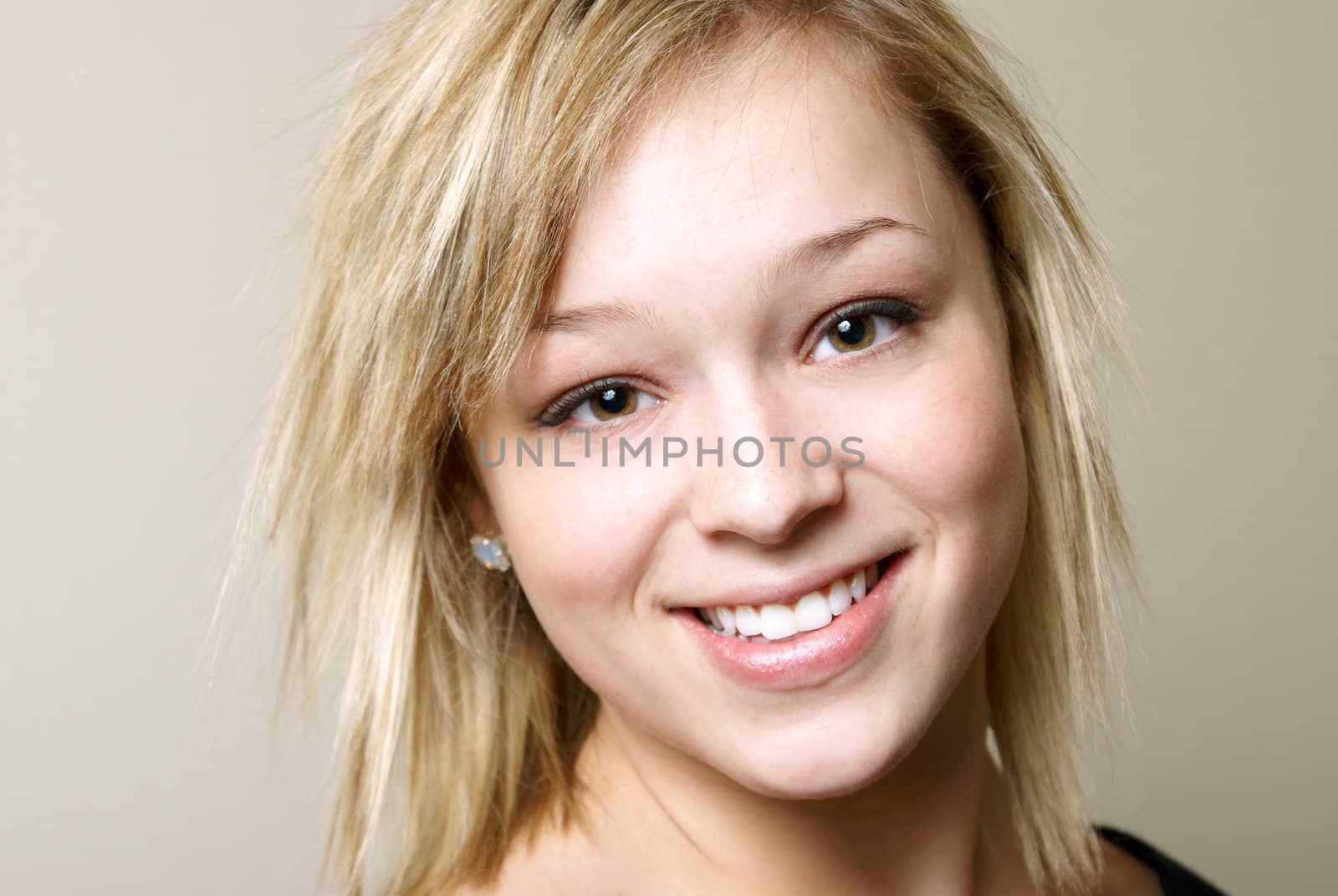 A portrait of a happy young woman who is smiling.