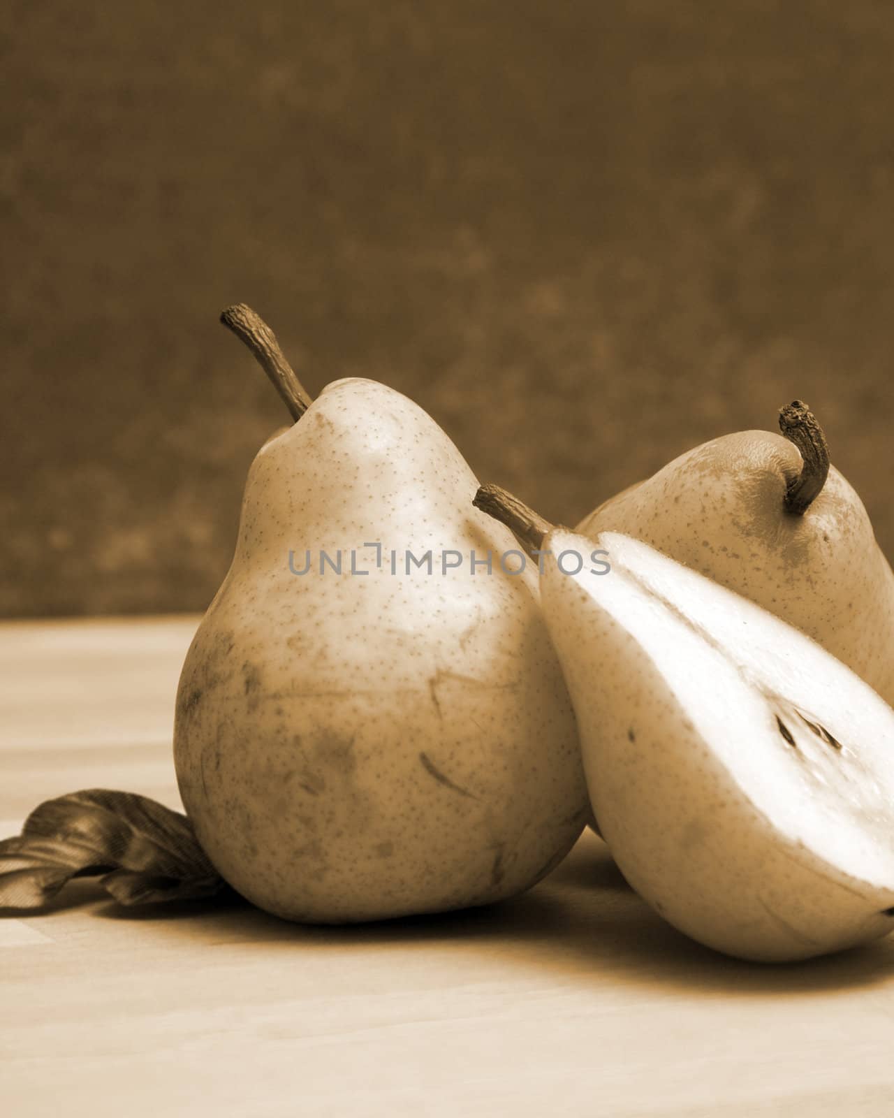 A few pears in a still life scene.