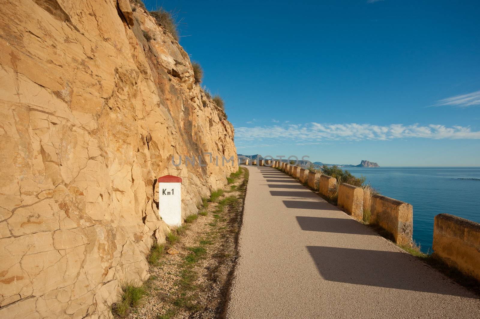 Narrow mountain road winding high above the Mediterranean