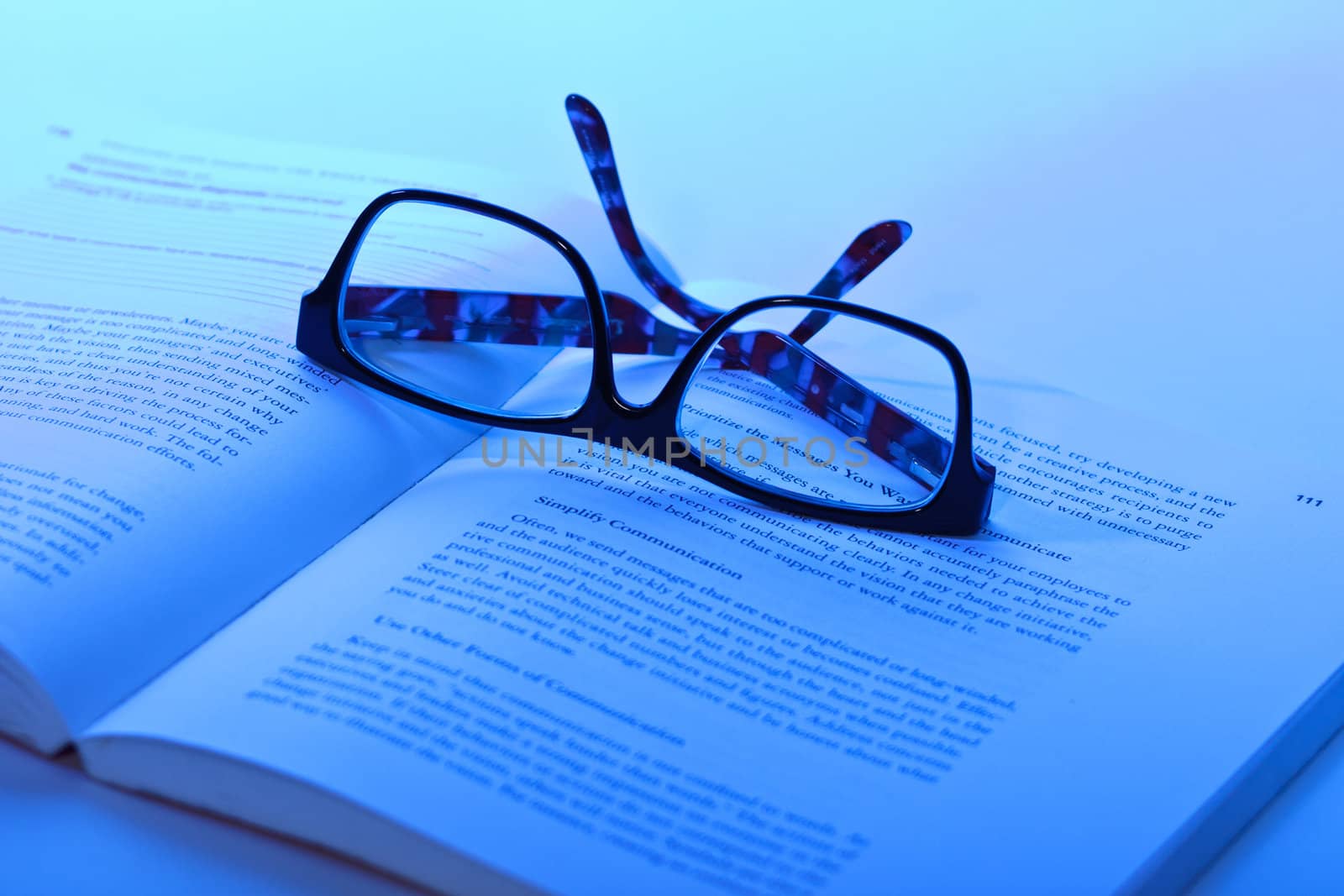 photo of eyeglasses lie on the book