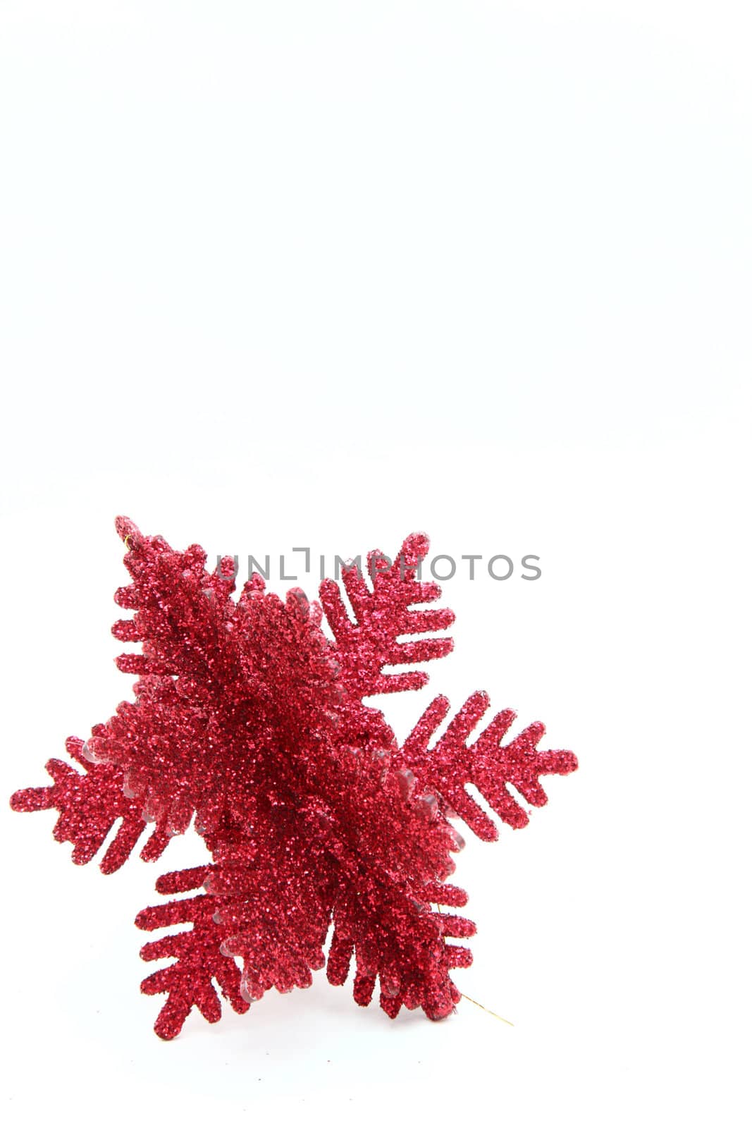 Red christmas snowflake ornament isolated on white