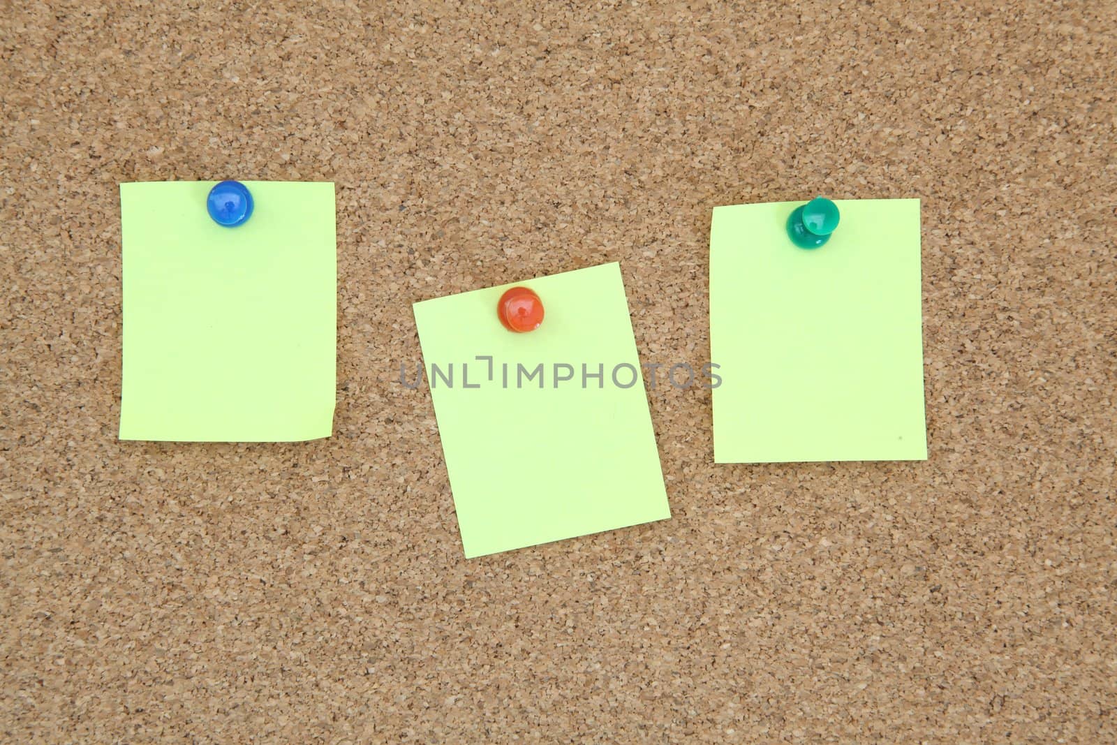 three yellow memo sticker on notice cork board